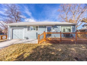 Charming light blue home with a cozy front porch and well-maintained lawn at 705 Kenton St, Aurora, CO 80010