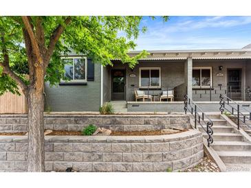 Charming home with a well-manicured front yard and inviting covered porch area at 3325 Irving St, Denver, CO 80211