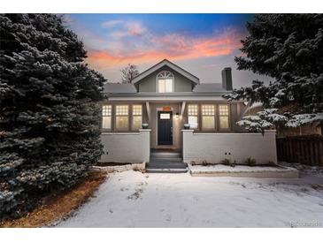 Charming home with a brick foundation, covered porch, and freshly painted exterior at 3438 N York St, Denver, CO 80205