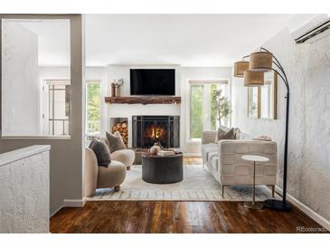Inviting living room with a cozy fireplace, hardwood floors, and stylish contemporary furnishings at 377 Pearl St # 5, Boulder, CO 80302