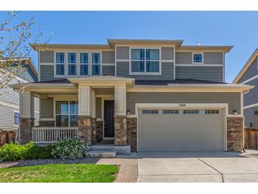 Beautiful two-story home with a well-manicured lawn and a charming front porch at 1226 S Fulton St, Aurora, CO 80247