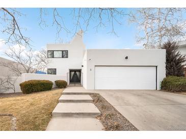 Stunning, modern exterior elevation with white stucco, clean lines, and xeriscaped front yard at 5401 E Dakota Ave # 3, Denver, CO 80246