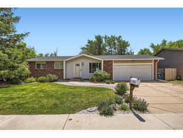 Charming home with brick accents, well-maintained lawn, and attached two-car garage at 9146 W 89Th Ct, Broomfield, CO 80021