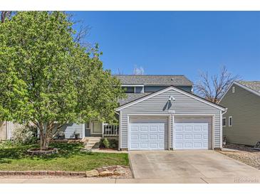 Charming two-story home with a two-car garage and well-maintained landscaping and mature shade tree at 4071 E 126Th Pl, Thornton, CO 80241