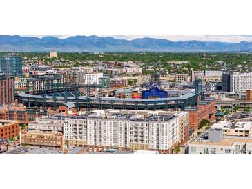 Stunning aerial view of Coors Field and the downtown Denver skyline with Rocky Mountain backdrop at 2150 Curtis St, Denver, CO 80205