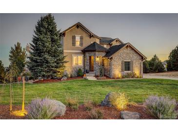 Two-story house with stone accents and landscaping at 5268 Talavero Pl, Parker, CO 80134