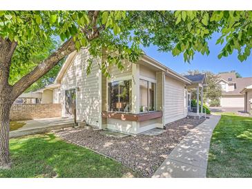 Charming single-story home with a well-maintained lawn and a peaceful, tree-shaded setting at 2288 S Depew St, Lakewood, CO 80227