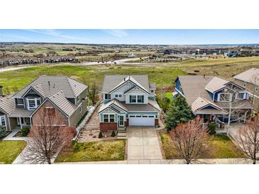 Beautiful two-story home with professional landscaping, large driveway, and mountain views at 12996 Banyon Cir, Parker, CO 80134