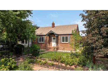 Charming brick home with landscaped front yard and black iron fence at 4419 W 34Th Ave, Denver, CO 80212