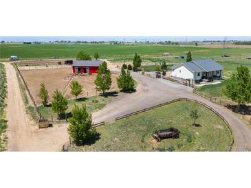 Beautiful property featuring a charming home, a horse barn, and fenced pastures on a spacious lot at 10691 County Road 23, Fort Lupton, CO 80621