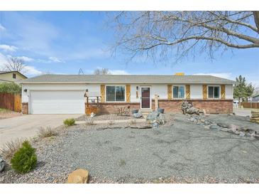 Charming ranch-style home with brick accents and landscaped front yard at 16097 E Cornell Pl, Aurora, CO 80013