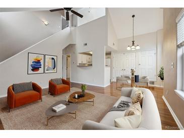 Bright living room with modern decor, hardwood floors, and comfortable seating at 14399 E Grand Dr # 150, Aurora, CO 80015