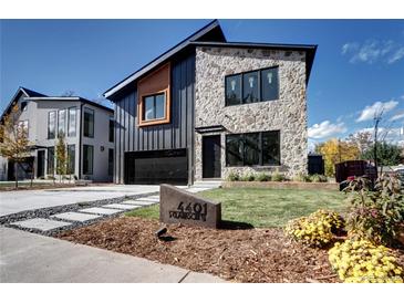 Stunning modern home exterior featuring stone accents, sleek black siding, and a well-manicured front lawn at 4401 S Clarkson St, Englewood, CO 80113