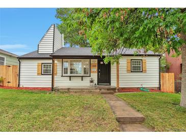 Charming home featuring a well-manicured lawn, quaint shutters, and a welcoming front entrance at 1325 Dayton St, Aurora, CO 80010
