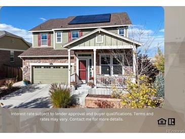 Charming two-story home featuring a covered front porch, stone accents, and solar panels on the roof at 3158 S Nepal Way, Aurora, CO 80013