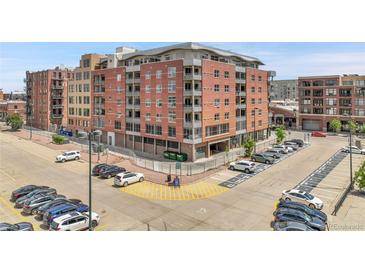Brick apartment building with balconies above a parking lot, perfect for city living at 2229 Blake St # 505, Denver, CO 80205