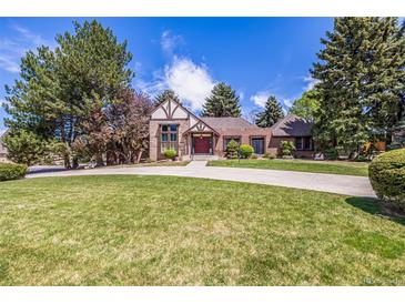 Charming two-story home with well-manicured lawn, mature trees and circular driveway at 5365 W Princeton Dr, Denver, CO 80235