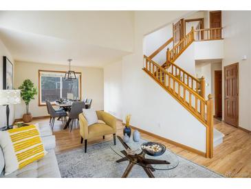 Bright living room boasts hardwood floors, modern decor, and an open layout leading to the dining area at 4565 Pussywillow Ct, Boulder, CO 80301