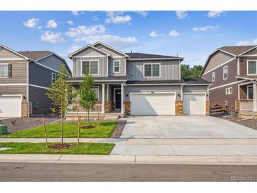 Beautiful two-story home with a three car garage, stone accents and landscaped front yard at 13465 Valentia Pl, Thornton, CO 80602