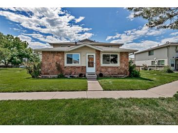 Charming home featuring a stone facade, well-maintained lawn and easy access to the front door at 3354 S Flower St # 52, Lakewood, CO 80227