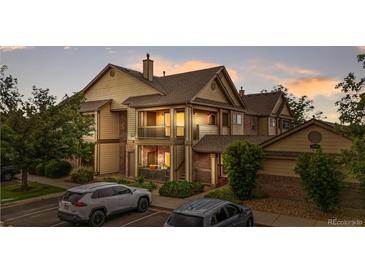Beautiful two-story condo with a covered balcony, brick accents, and well-maintained landscaping with assigned parking at 23456 E 5Th Pl # 104, Aurora, CO 80018