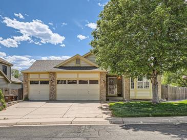 Charming single-Gathering home with a three-car garage and mature landscaping in a peaceful neighborhood at 1649 Iris St, Broomfield, CO 80020