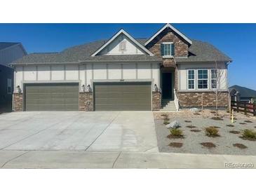 Charming two-story home featuring a three-car garage and manicured landscaping at 3867 Freestone Pt, Castle Rock, CO 80108
