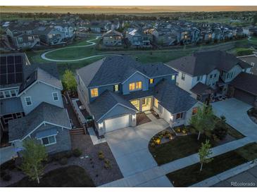 A beautiful two-story home with an attached garage and manicured landscaping at 8179 S Kellerman Cir, Aurora, CO 80016