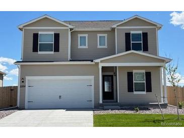 Charming two-story home with a front-facing two car garage, green lawn, and black window shutters at 2204 Alyssa St, Fort Lupton, CO 80621
