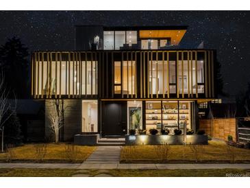 Striking modern home exterior featuring unique architectural details and beautiful nighttime curb appeal at 580 S Franklin St, Denver, CO 80209