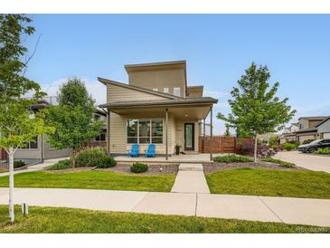 Contemporary two-story home featuring a well-manicured front yard, a covered porch, and stylish architectural details at 9636 Bennett Peak St, Littleton, CO 80125
