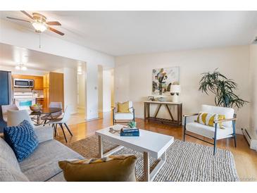 Bright living room features hardwood floors, and an open floor plan at 720 S Clinton St # 9D, Denver, CO 80247