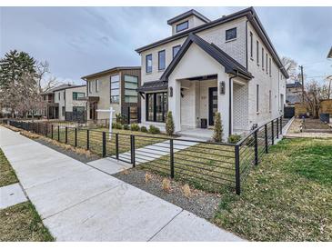 Modern two-story home with a white brick facade and black accents at 521 Milwaukee St, Denver, CO 80206