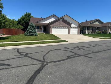 Charming two-story home with a three-car garage and a well-manicured lawn at 11237 W 55Th Ln, Arvada, CO 80002