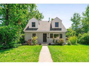 Charming home with a well-maintained front yard, blossoming roses, and inviting walkway at 1856 S Monroe St, Denver, CO 80210