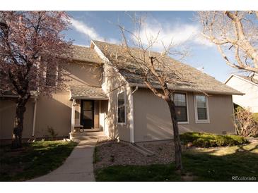 Charming two-story home with neutral siding, walkway, and lush landscaping at 2625 S Xanadu Way # E, Aurora, CO 80014