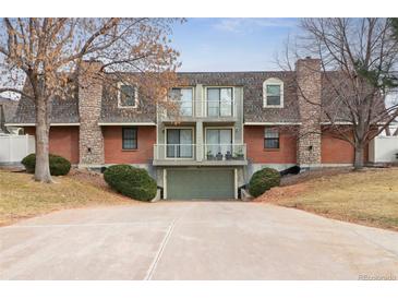 Two-story condo featuring brick and stone accents, balconies, and garage at 1390 S Idalia St # 39F, Aurora, CO 80017