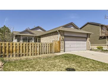 Charming single-Gathering home with a well-maintained lawn and a wooden fence at 7075 Routt St, Arvada, CO 80004