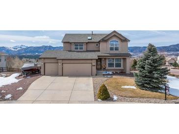 Charming two-story home with a two car garage and mountain views on a sunny day at 15640 Agate Creek Dr, Monument, CO 80132