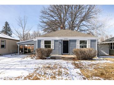 Charming blue house featuring a well-maintained front yard and a convenient attached carport at 2773 S Franklin St, Denver, CO 80210