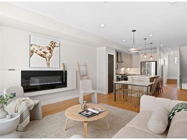 Bright, open living room features a fireplace, modern decor, and hardwood floors at 4917 Lowell Blvd # 105, Denver, CO 80221