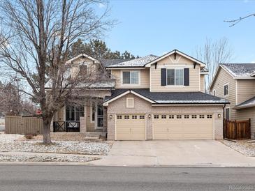 Charming two-story home featuring a three-car garage and well-maintained landscaping at 6583 W Gould Dr, Littleton, CO 80123