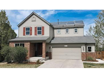 Charming two-story home featuring solar panels, a two-car garage, and a well-maintained front yard at 961 Stanley Ct, Erie, CO 80516