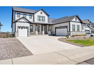 Stunning two-story home with a three-car garage and welcoming front porch at 3293 Offbeaten Pl, Castle Rock, CO 80108