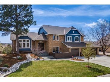 Charming two-story home features a manicured lawn, three car garage and tasteful landscaping at 2162 Terraridge Dr, Highlands Ranch, CO 80126