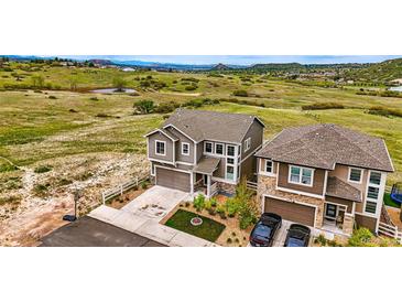 Lovely two-story home featuring a two-car garage, neutral paint, and beautiful landscaping at 2511 Loon Ln, Castle Rock, CO 80104