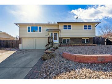 Inviting two-story home featuring a well-maintained front yard and attached two-car garage at 1231 Missouri Ave, Longmont, CO 80501