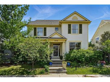 Charming two-story home with a landscaped front yard, steps and beautiful plants in a vibrant neighborhood at 8256 E 28Th Dr, Denver, CO 80238