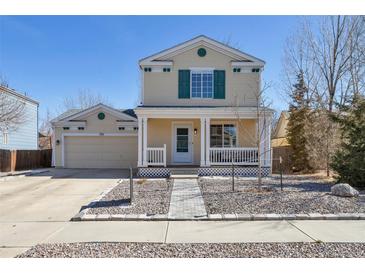 Charming two-story home with a welcoming front porch and well-maintained landscaping at 335 Tynan Dr, Erie, CO 80516