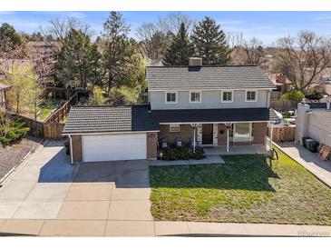 Charming two-story home featuring brick accents, a covered porch, and a spacious two-car garage at 9940 Pecos St, Thornton, CO 80260